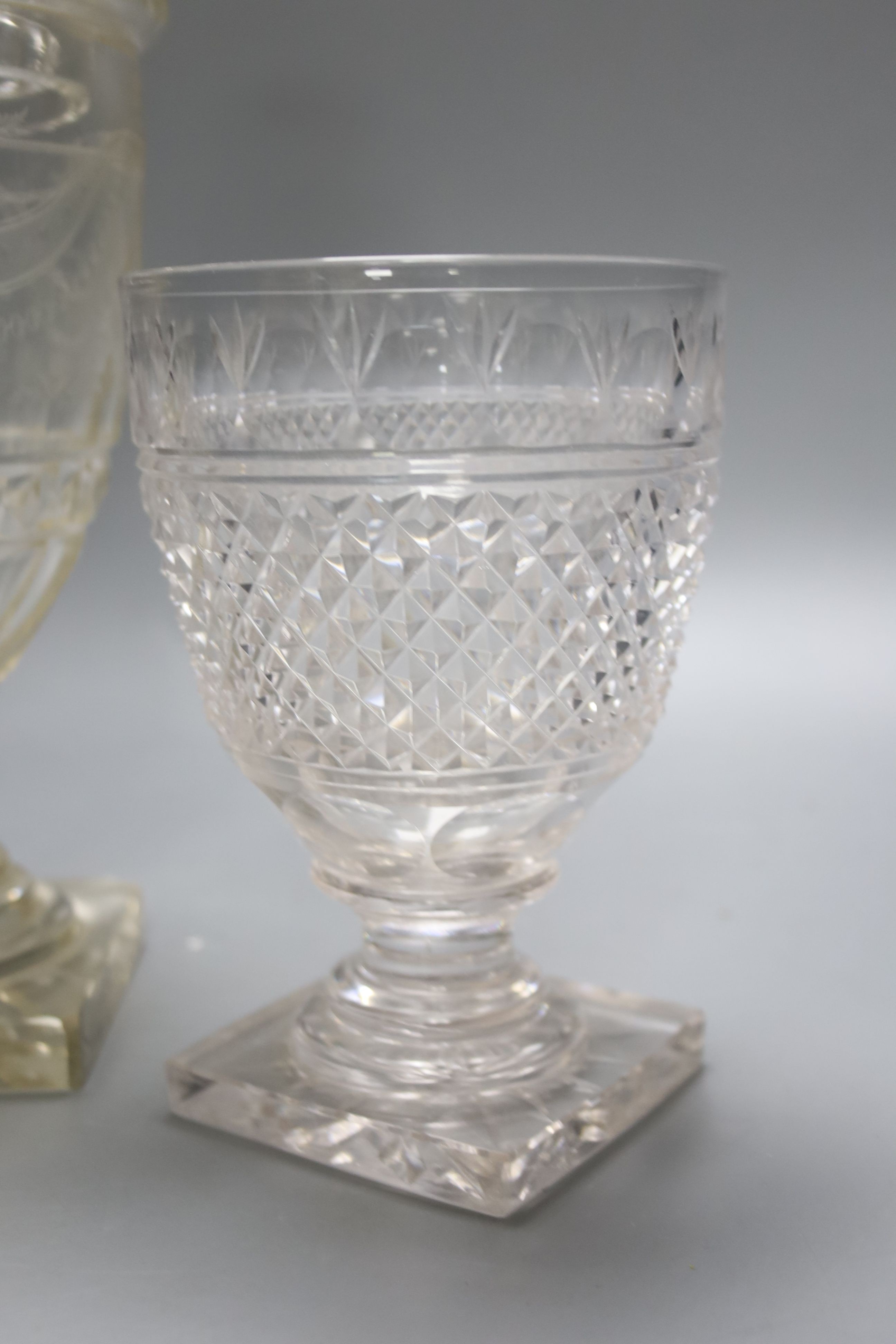 A Regency cut glass urn and cover and another urn